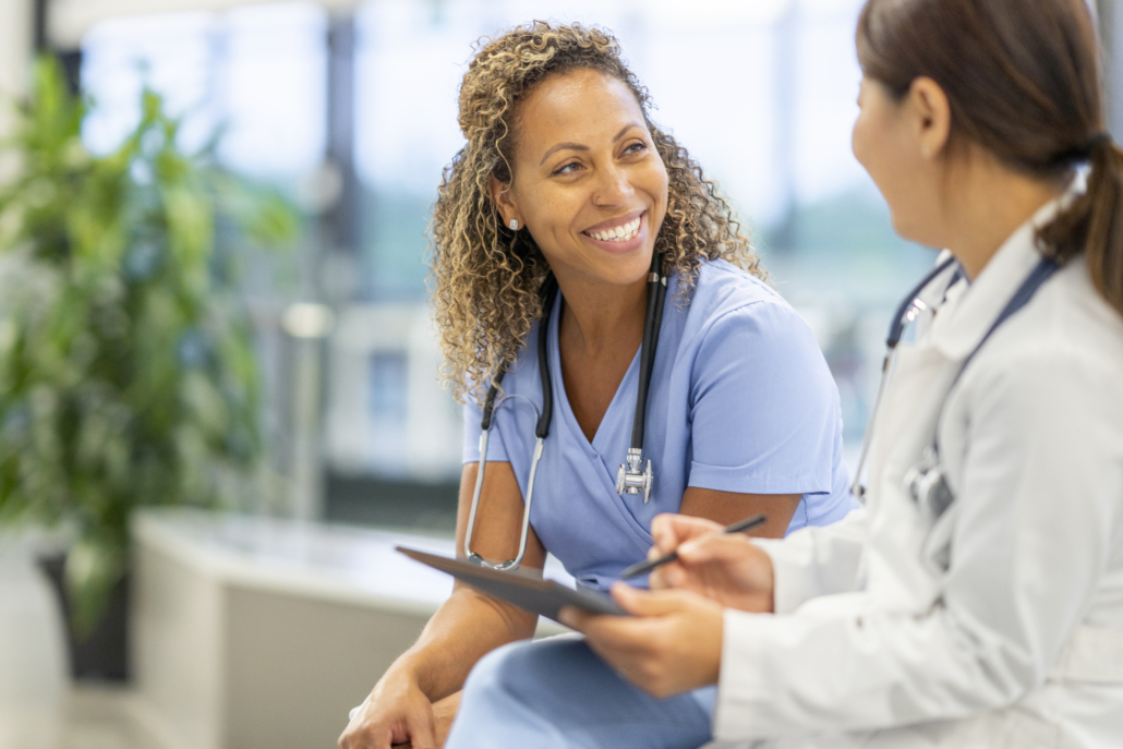 Two female doctors discuss their patient's results with each other, consulting each other and sharing their expertise.